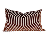 Rectangular pillow with a bold geometric pattern in rust and dark brown velvet, featuring concentric angular lines forming a symmetrical design.