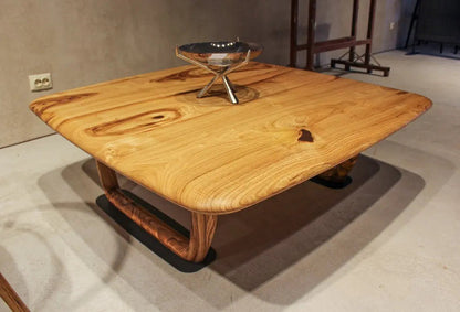 Rustic solid chestnut wood coffee table with chestnut legs in living room setting