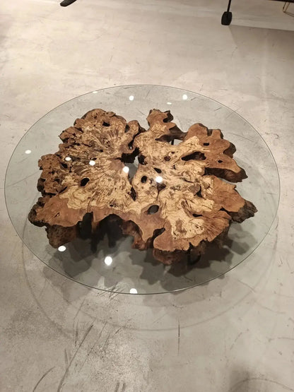 Olive wood rustic coffee table with clear glass top and stone-inspired wooden legs