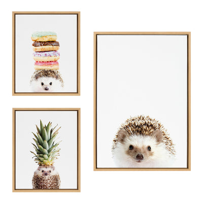 Three framed canvas art prints titled Hedgehog, Hedgehog Donuts, and Hedgehog Pineapple by Amy Peterson Art Studio displayed on a wall.