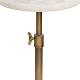 Close-up of a brass adjustable clamp and post supporting a round white marble tabletop with subtle beige veining.