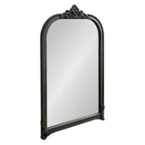 Tall arched wall mirror with ornate black frame featuring carved floral crest at the top and beaded detailing along the edges, shown against a white background.