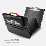 Black dual-panel solar array with orange handles, labeled Dark Energy and Spectre, shown folded in a V-shape with a carrying pouch attached for transport.