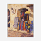 Painting of a market stall with colorful sarape blankets in vibrant red, blue, and yellow hanging outside a sunlit stucco wall, accented by a sunflower and straw hat.