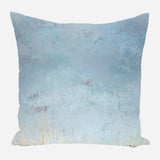 Square pillow with a soft gradient of blue and off-white, featuring subtle textured and distressed patterns resembling weathered paint.