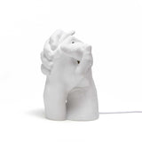 White sculptural lamp shaped like two hands delicately holding each other, with smooth matte finish and a power cord extending from the base.