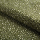 Close-up of Serra pillow cover fabric showing a textured woven pattern in chive green with subtle off-white accents.