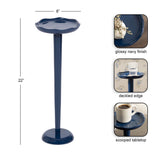 Glossy navy blue drink table with a 22-inch tall slender stem, scalloped deckled edge, and scooped tabletop surface shown with a cup and glass.