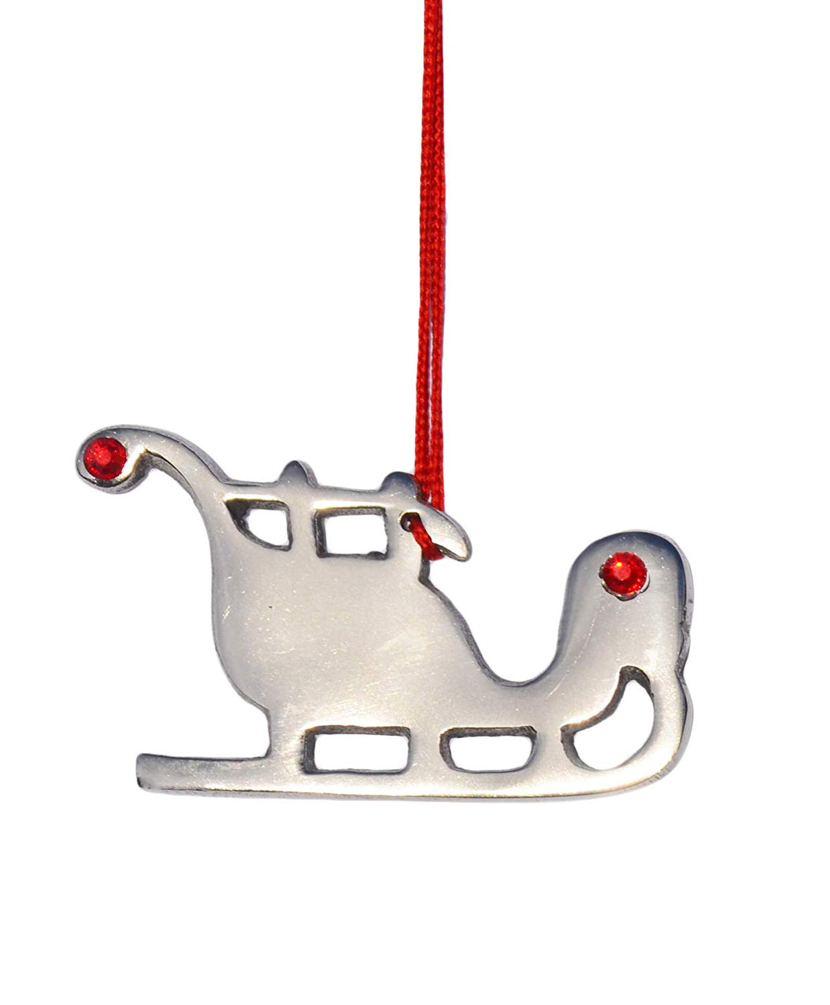 Silver metal sleigh Christmas ornament with cut-out windows and two small red gem accents hanging from a red string against a white background.
