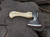 Small carving axe with carbon steel blade and ash wood handle, featuring leather sheath with belt loop