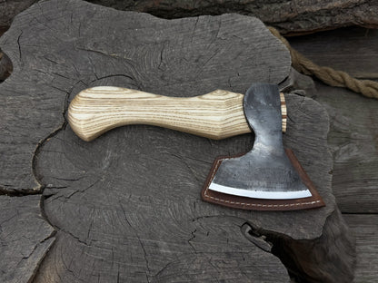 Small carving axe with carbon steel blade and ash wood handle, featuring leather sheath with belt loop