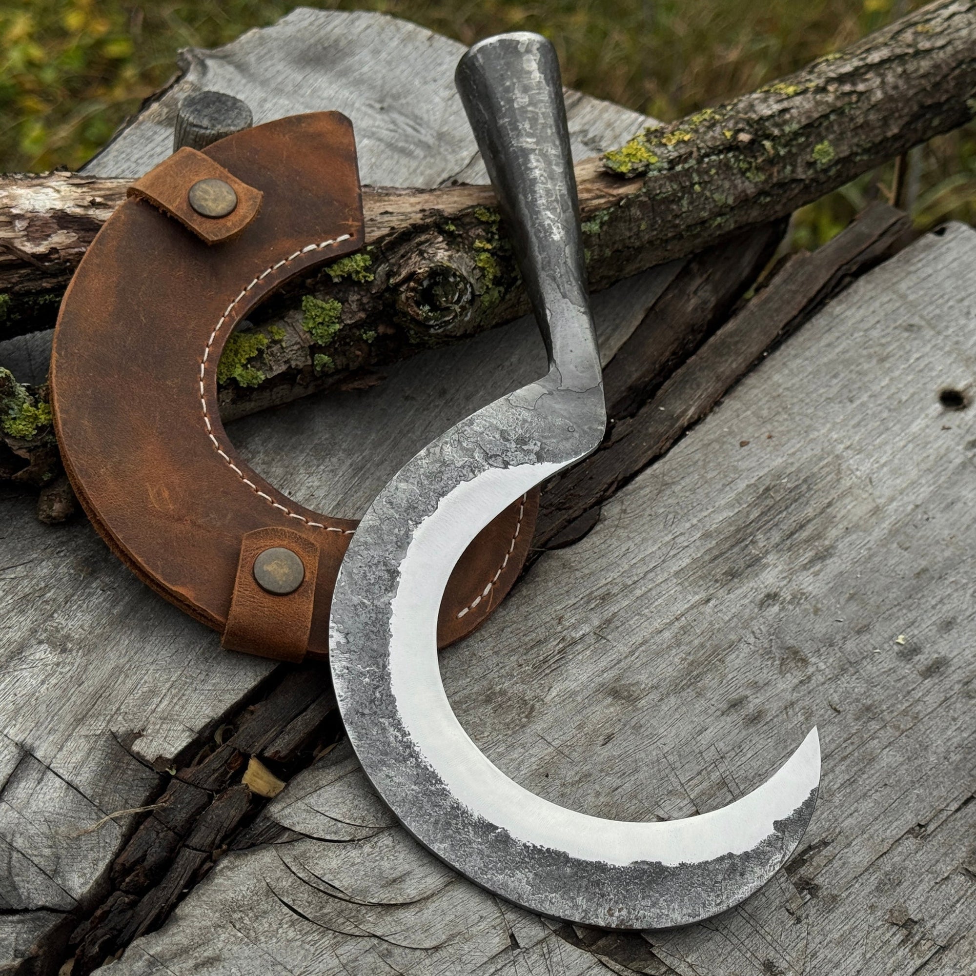 Small sickle with forged handle and leather sheath for gardening and harvesting