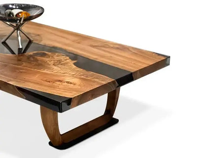 Handcrafted resin coffee table with smoke-colored resin river and solid walnut legs