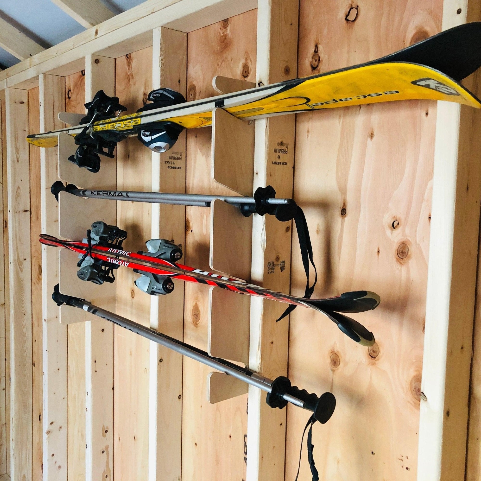 Snow & Water Ski Storage Rack mounted in a shed holding snow skis and ski poles
