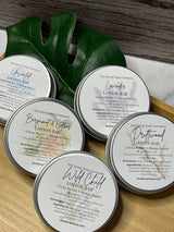 Solid Lotion Bars in reusable metal tins arranged neatly, showcasing natural skincare packaging.