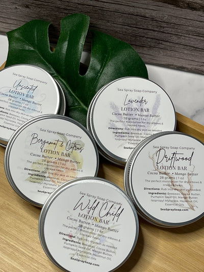 Solid Lotion Bars in reusable metal tins arranged neatly, showcasing natural skincare packaging.