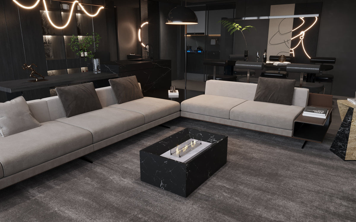 Modern living room with two light beige sofas facing a black marble rectangular coffee table featuring a built-in linear fireplace, all set on a textured gray rug.