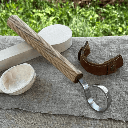 Hand-forged spoon carving hook knife with curved blade and ash wood handle