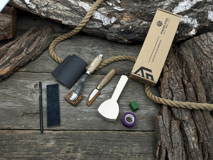 Spoon Carving Kit with bent gouge, whittling knife, wooden blank, sandpaper, sharpening board, pencil, and finger wrap