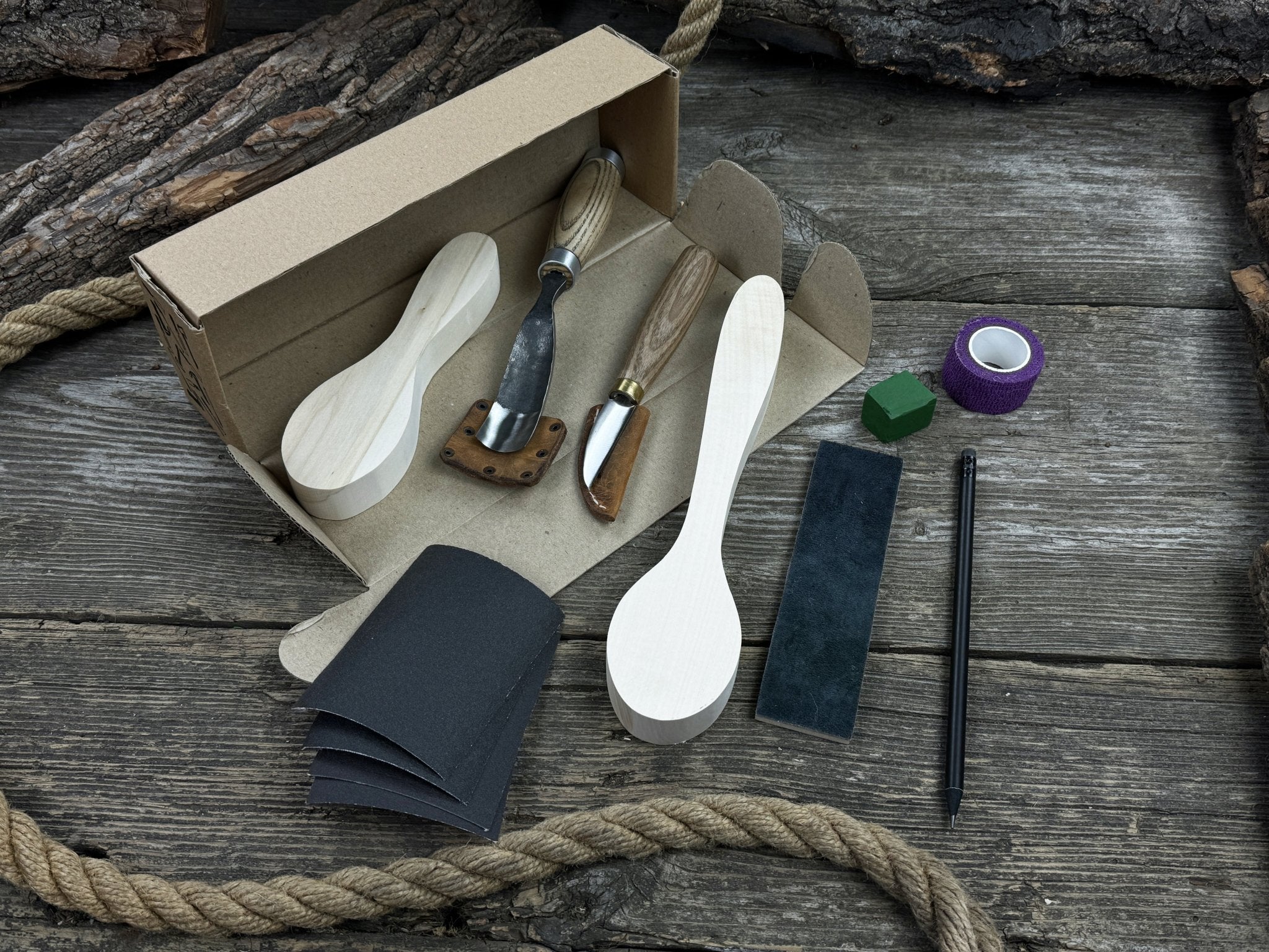Complete Spoon Carving Kit with wood blanks, hand-forged tools, sandpaper, and accessories