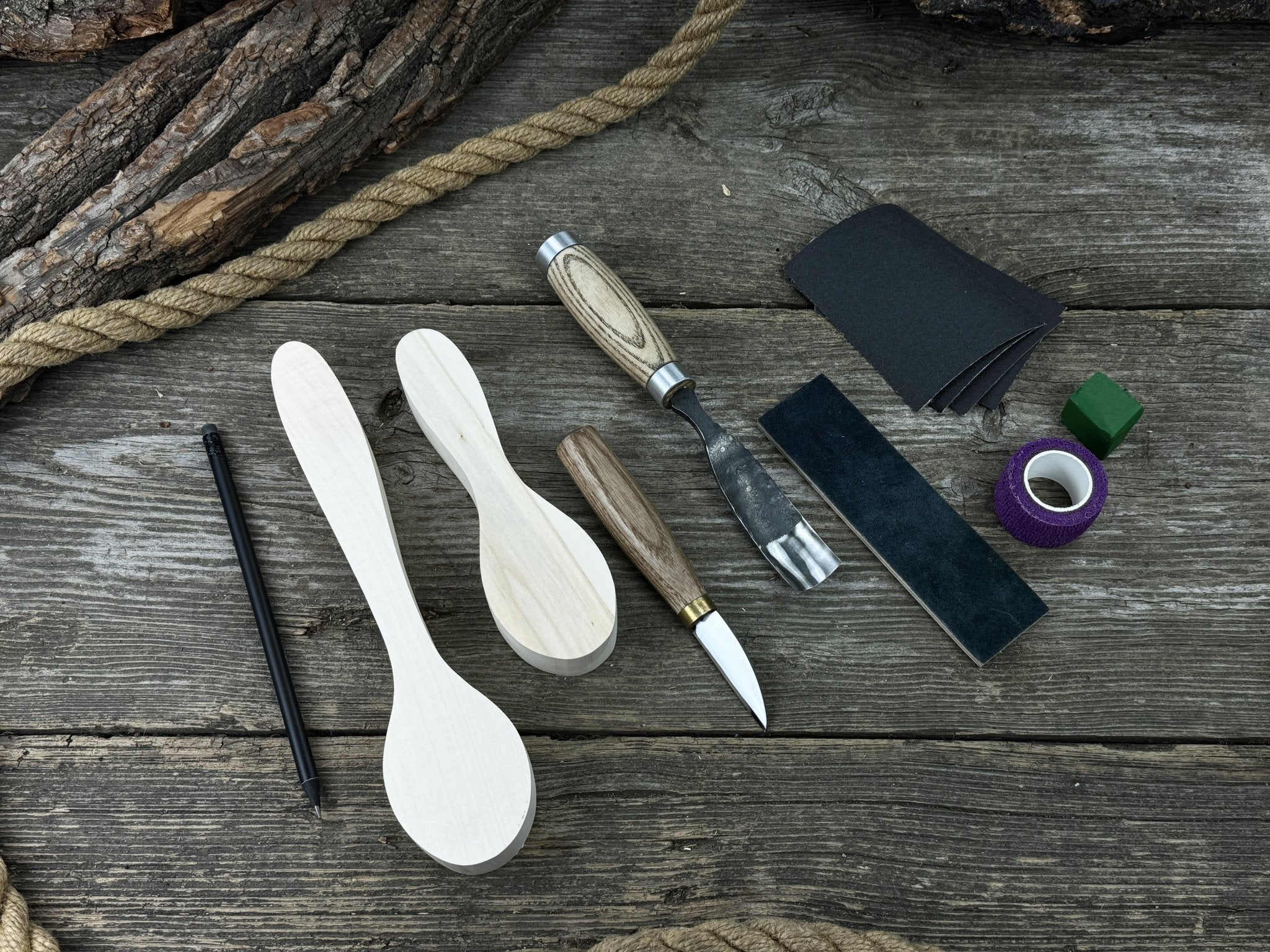 Complete Spoon Carving Kit with wood blanks, hand-forged tools, sandpaper, and accessories