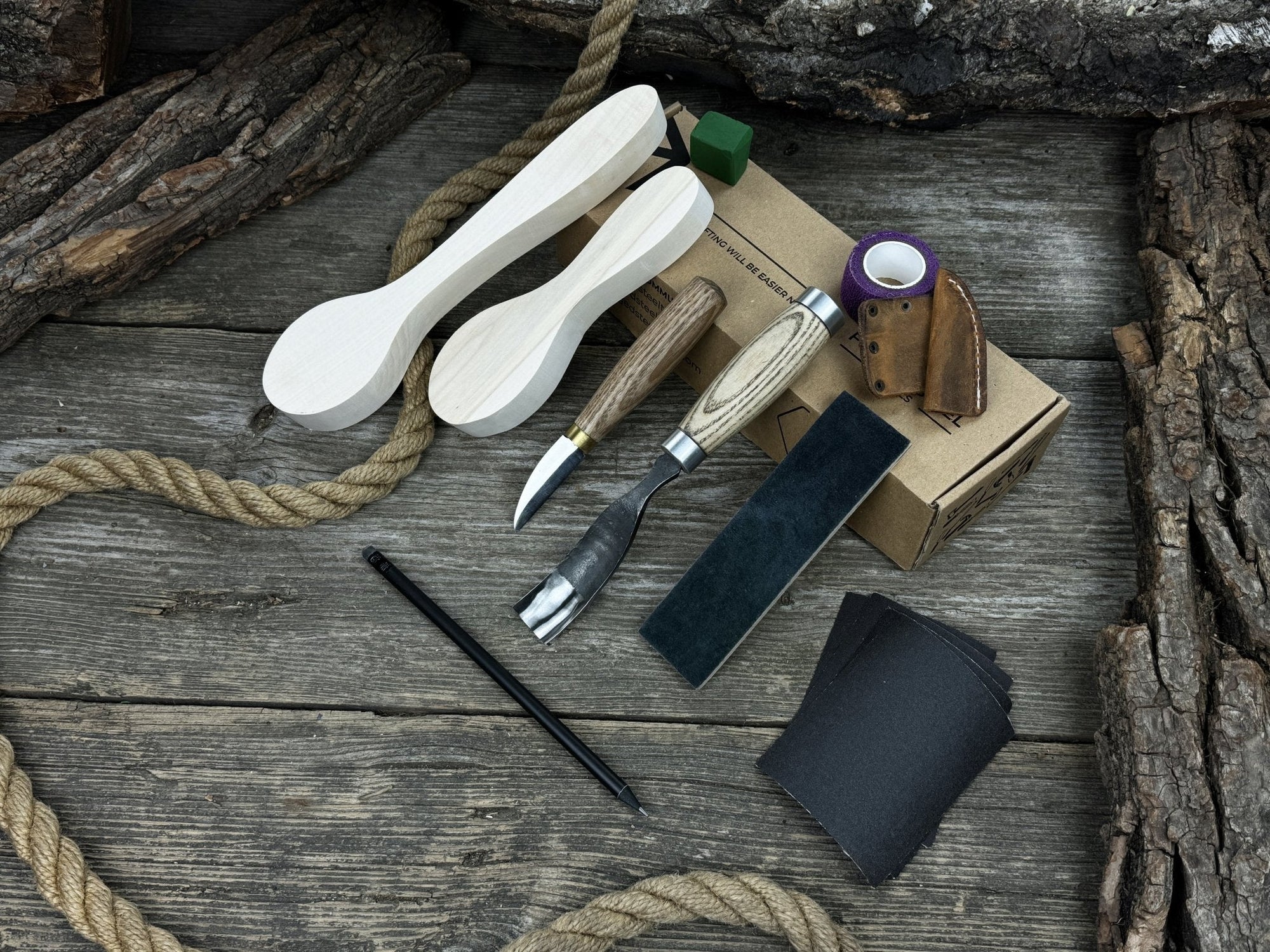 Complete Spoon Carving Kit with wood blanks, hand-forged tools, sandpaper, and accessories