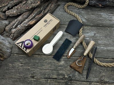 Spoon Carving Kit with knives, wooden blank, sandpaper, sharpening board, pencil, and finger wrap