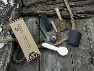Spoon Carving Kit with knives, wooden blank, sandpaper, sharpening board, pencil, and finger wrap