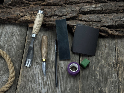 Spoon Carving Kit with hand-forged tools, wooden blanks, sandpaper, and sharpening board