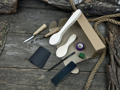 Complete spoon carving kit with knives, wooden blanks, sandpaper, sharpening board, pencil, and finger wrap