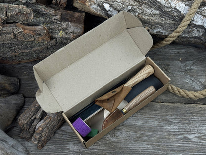Spoon Carving Kit with knives, wooden blank, sandpaper, sharpening board, pencil, and finger wrap