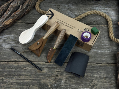 Spoon Carving Kit with knives, wooden blank, sandpaper, sharpening board, pencil, and finger wrap