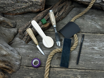 Spoon Carving Kit with knives, wooden blank, sandpaper, sharpening board, pencil, and finger wrap