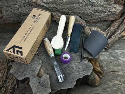 Spoon Carving Kit with knives, wooden blank, sandpaper, sharpening board, pencil, and finger wrap