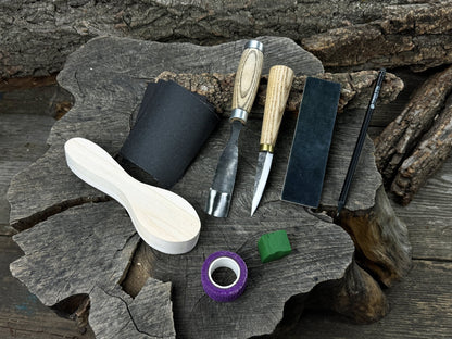 Spoon carving kit with sharpened tools, wooden blank, sandpaper, sharpening board, pencil, and finger wrap