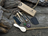 Spoon carving kit with sharpened tools, wooden blank, sandpaper, sharpening board, pencil, and finger wrap