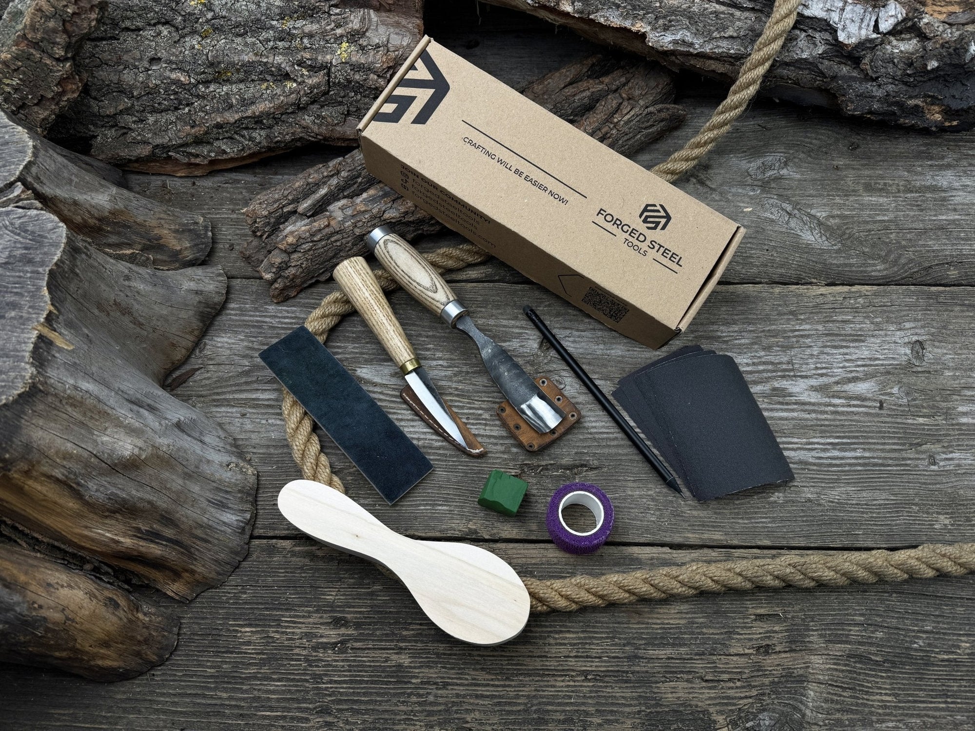 Spoon carving kit with sharpened tools, wooden blank, sandpaper, sharpening board, pencil, and finger wrap