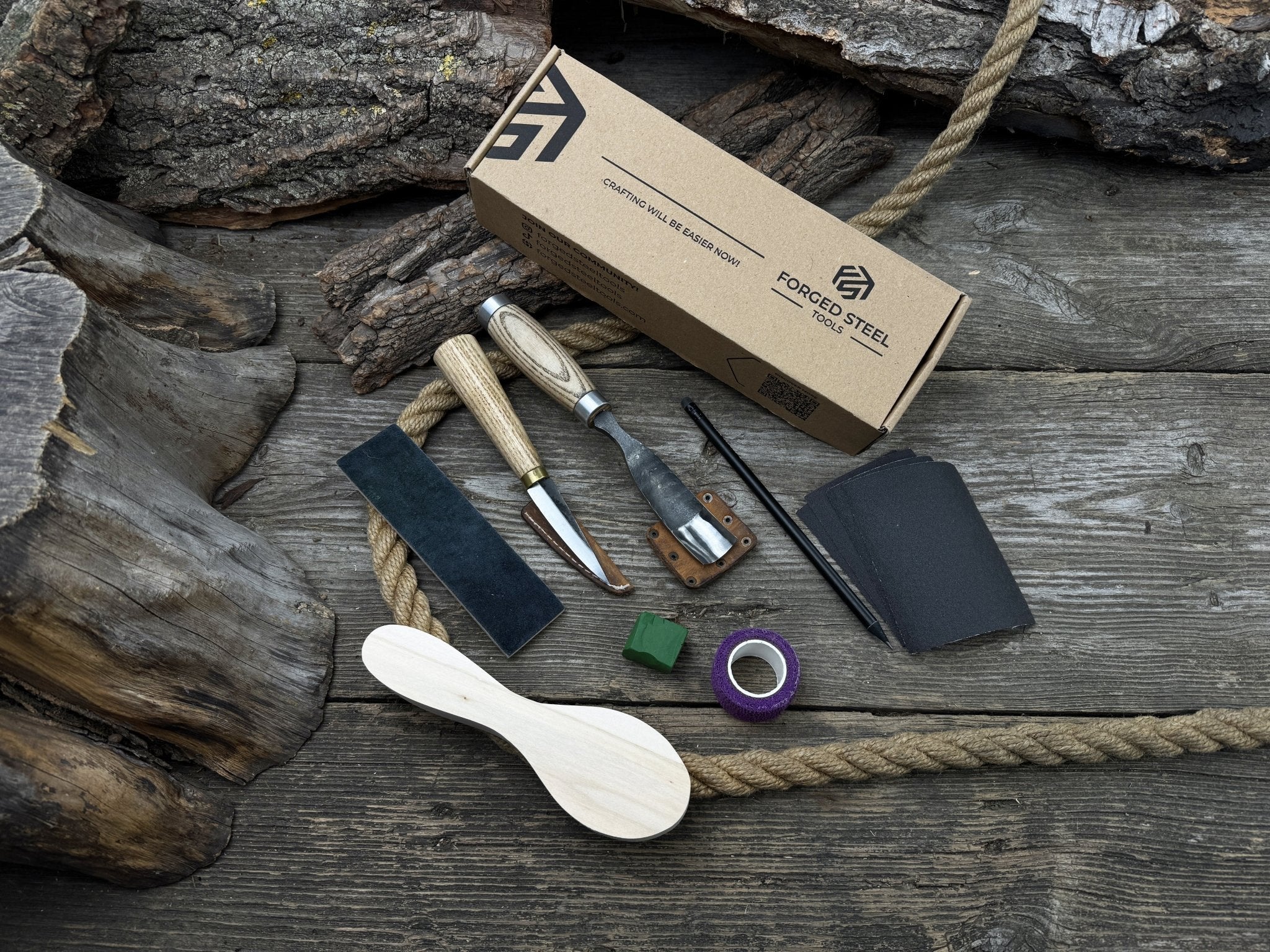 Spoon carving kit with sharpened tools, wooden blank, sandpaper, sharpening board, pencil, and finger wrap