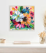 Square framed canvas painting with bright, colorful flowers in shades of pink, orange, blue, and white, accented with green leaves and bold brushstrokes.
