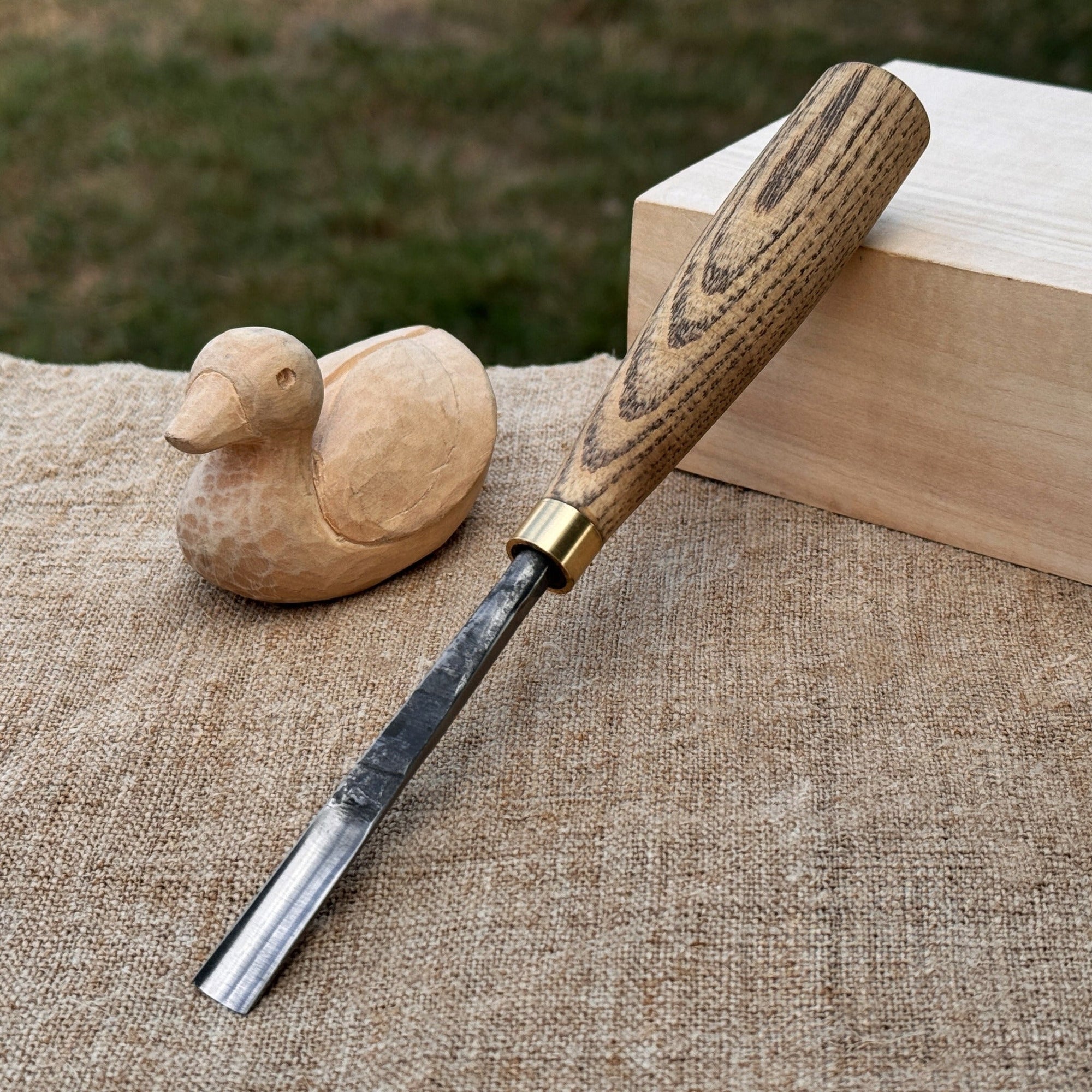 Straight wood carving gouge with ash wood handle and high-carbon steel blade, available in 5 mm and 12 mm widths