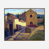 Oil painting of a sunlit Portuguese village street with a large, ochre church featuring arched windows and a peaked roof under a blue sky with distant hills.