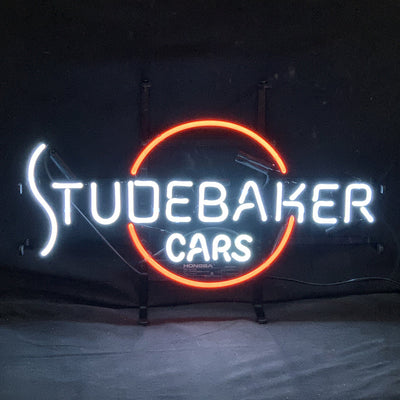 Studebaker Cars Auto Neon Sign Light mounted on a wall with glowing red neon tube in car shape