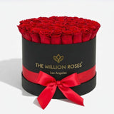 Black Supreme Box containing 26-28 naturally preserved red roses arranged tightly within.