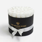 Black box containing 26-28 preserved white roses arranged closely