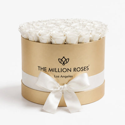Supreme Gold Box containing 26-28 white preserved roses arranged neatly, showing a close-up of the gold box and white roses