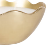 Close-up of a matte gold metal candle bowl with a smooth, wavy rim and a white candle wick visible inside.