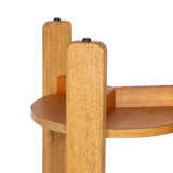 Close-up of a round wooden side table with a warm honey finish, featuring vertical rounded legs and a smooth flat tabletop edge