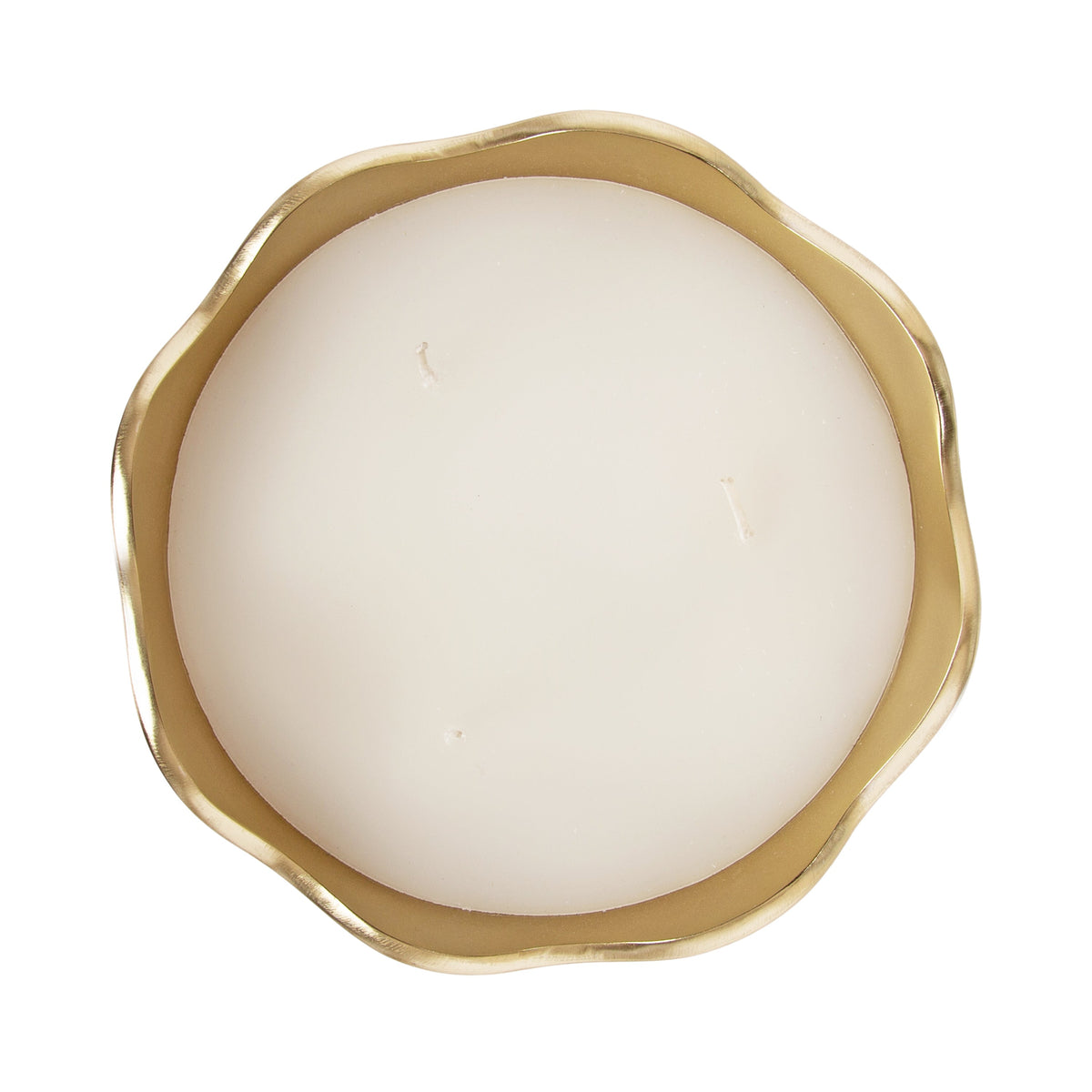 Round white candle with three wicks in a gold metal bowl featuring an irregular wavy rim, shown from above on a white background.