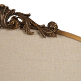 Close-up of an Arendahl Arch Framed Pinboard's top edge, featuring intricate gold-toned scroll and leaf carvings above a beige linen-covered board.
