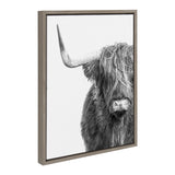 Framed black and white photograph showing a close-up of a Highland cow with long shaggy hair partially covering its eyes, facing forward with one horn visible.